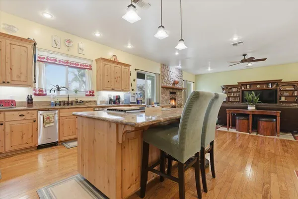 a kitchen with granite countertop white cabinets and a window