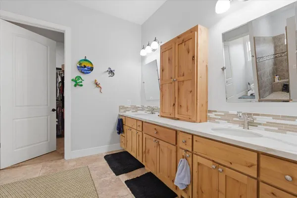 a bathroom with a granite countertop sink mirror and double
