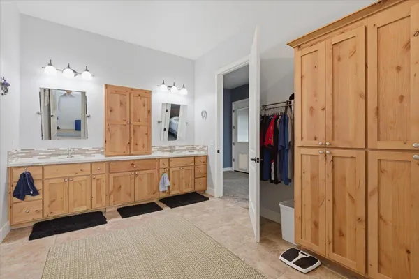 a spacious bathroom with a double vanity sink mirror and