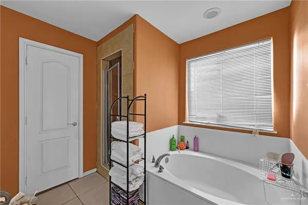 a bathroom with a bathtub and next to a window