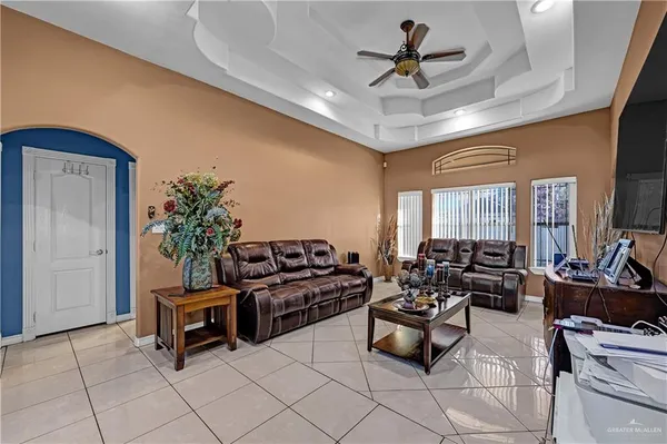 a living room with furniture gym equipment and a chandelier