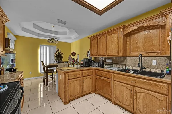 a kitchen with a sink counter top space appliances and cabinets