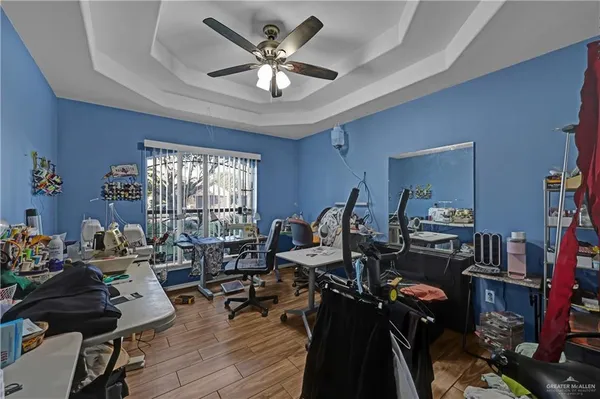 a view of a workspace with furniture and a window