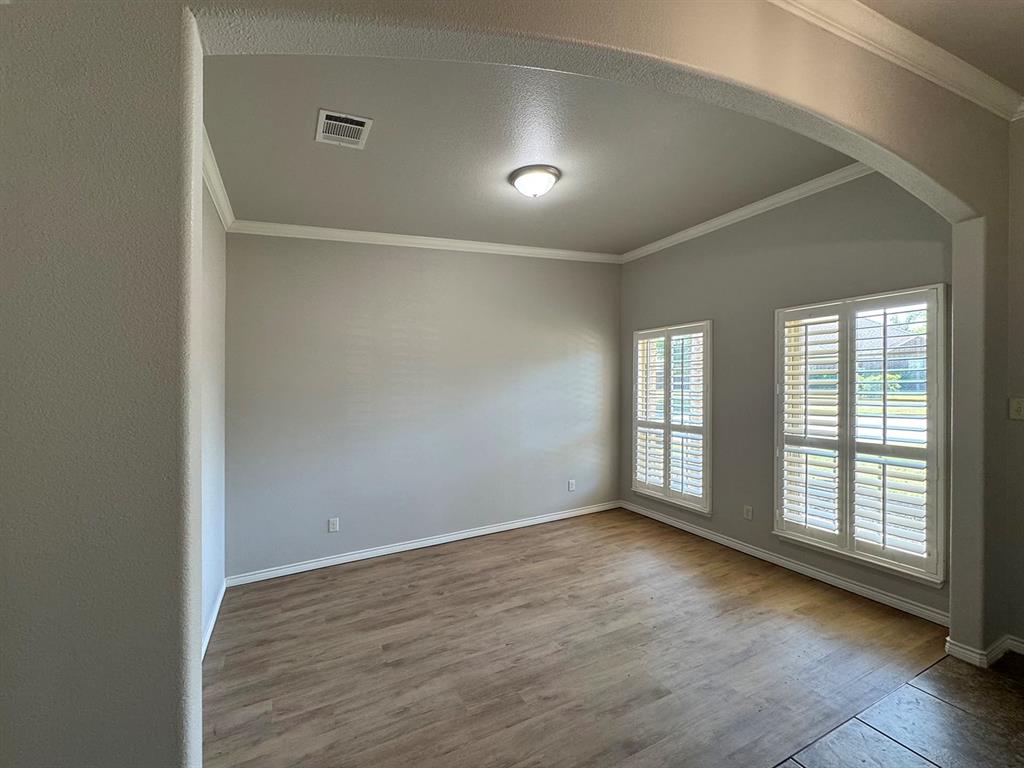 1113 Seguin Road Forney, TX 75126 - Photo 14 of 32 an empty room with wooden floor and windows