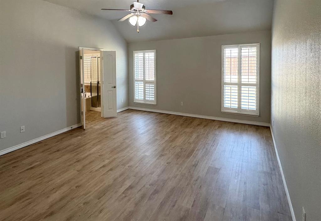 1113 Seguin Road Forney, TX 75126 - Photo 21 of 32 an empty room with wooden floor and windows