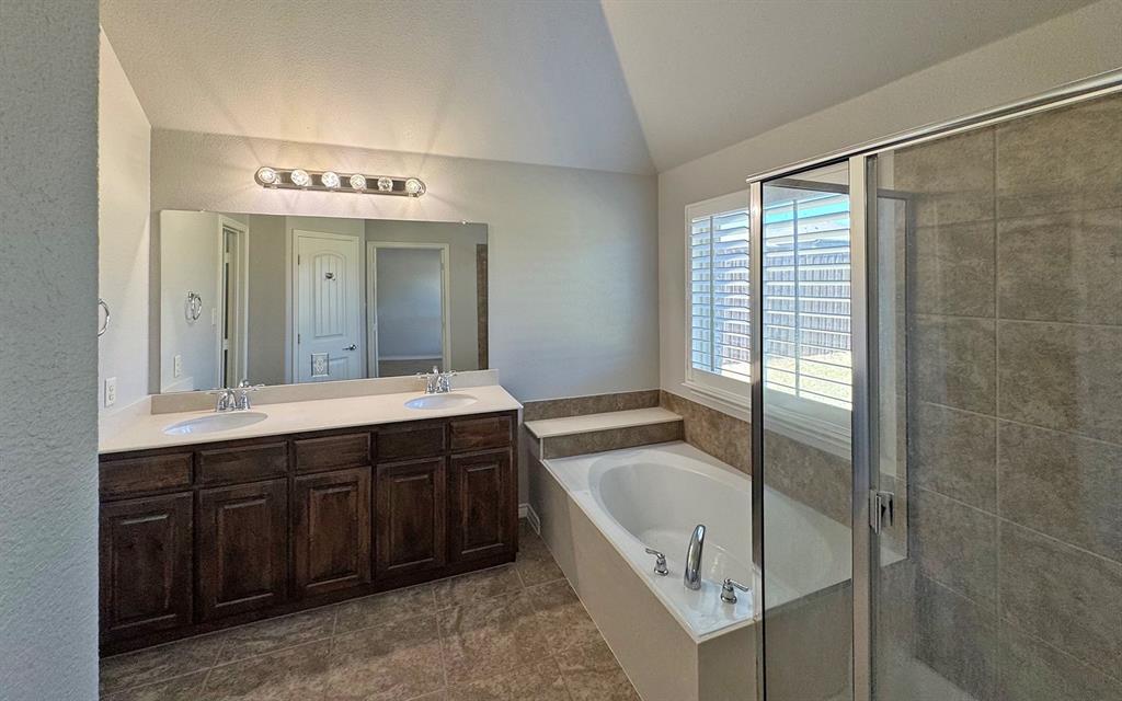 1113 Seguin Road Forney, TX 75126 - Photo 22 of 32 a spacious bathroom with a tub sink and mirror