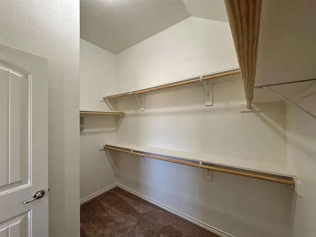 an empty room with closet and a window