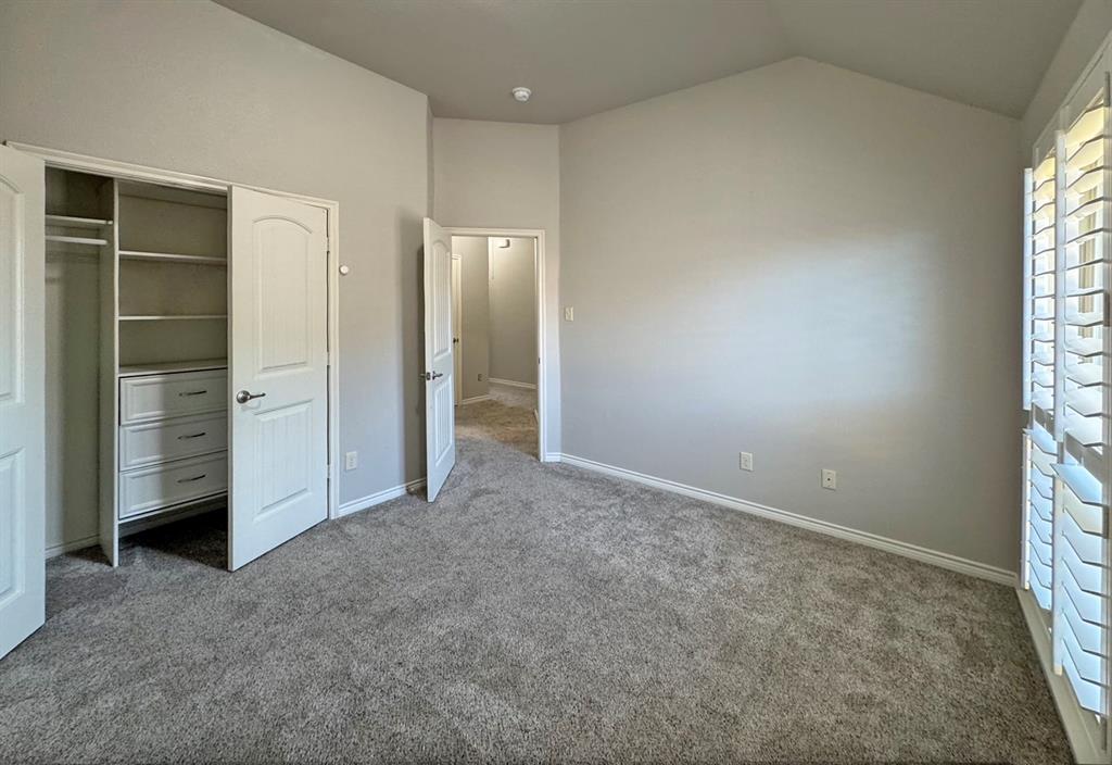 1113 Seguin Road Forney, TX 75126 - Photo 25 of 32 an empty room with closet and windows