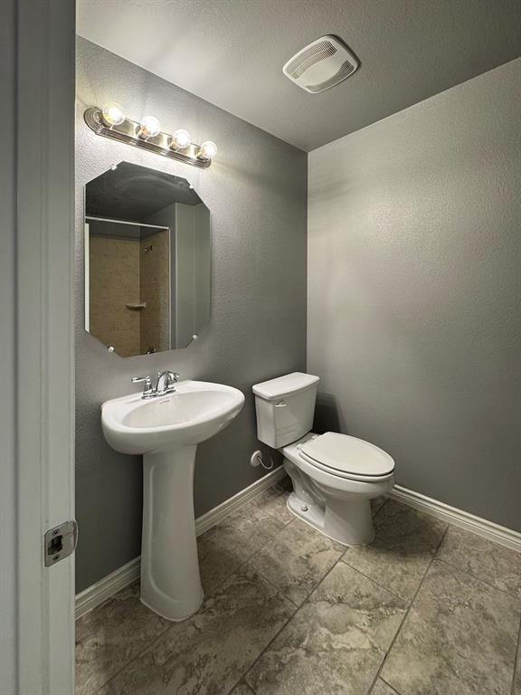 1113 Seguin Road Forney, TX 75126 - Photo 28 of 32 a bathroom with a toilet sink and mirror