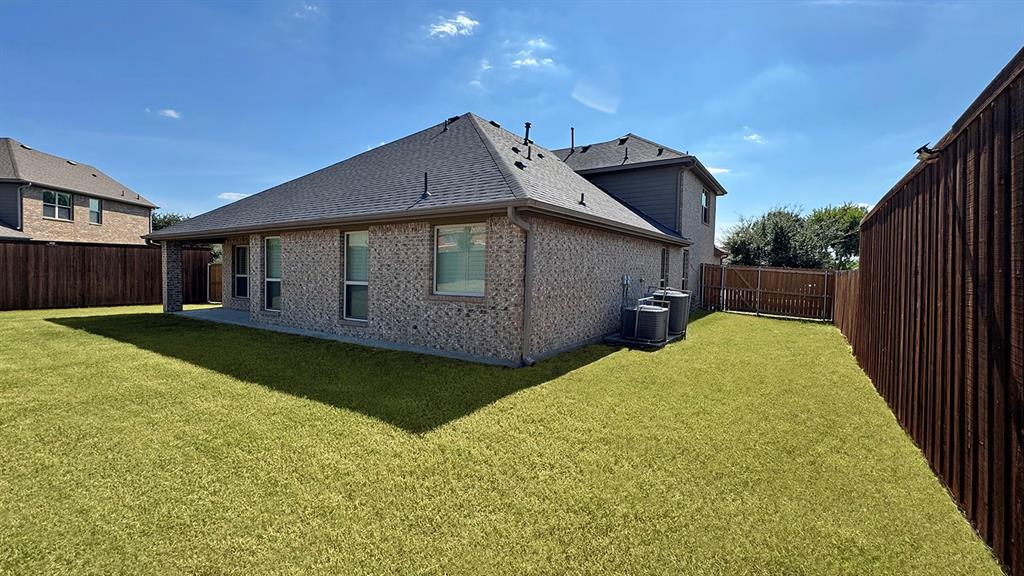 1113 Seguin Road Forney, TX 75126 - Photo 5 of 32 a backyard of a house with yard and garage