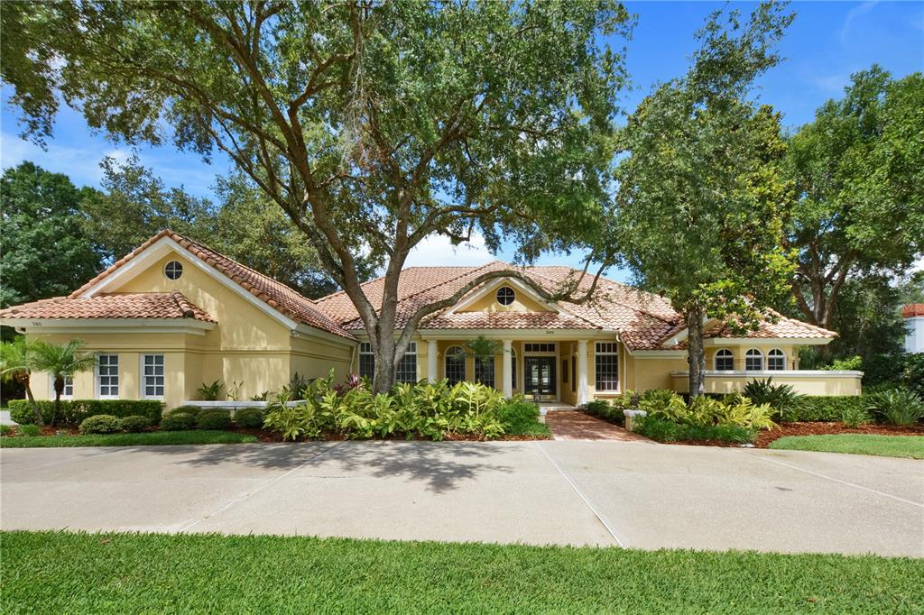 a front view of a house with yard and green space