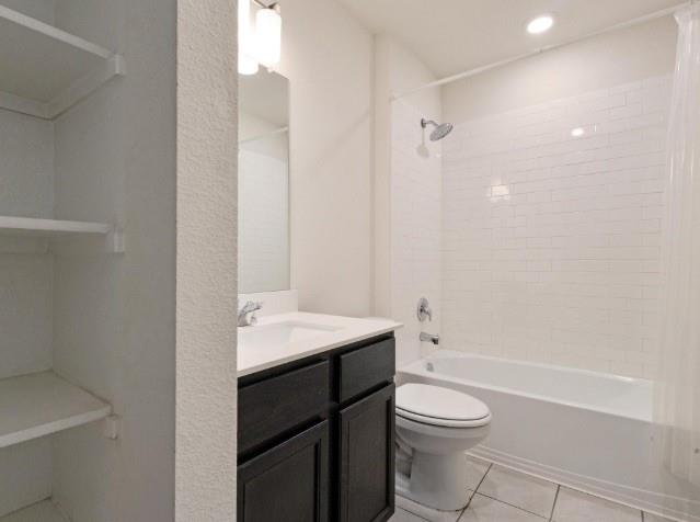 1223 Trevino Road Forney, TX 75126 - Photo 13 of 20 a bathroom with a sink a toilet and shower