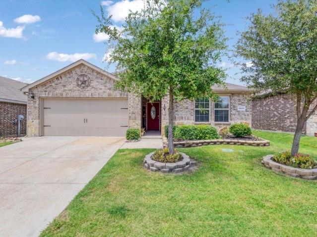 1223 Trevino Road Forney, TX 75126 - Photo 18 of 20 a front view of a house with a yard and garage