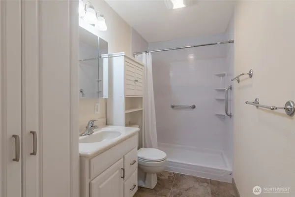 a bathroom with a sink toilet and shower