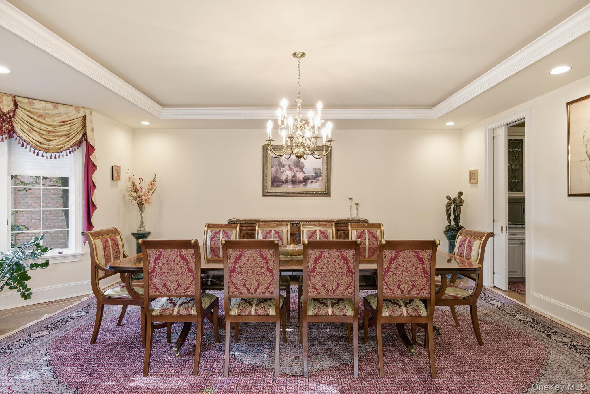 19 Cobblestone Court Centerport, NY 11721 - Photo 17 of 45 a view of a dining room with furniture and chandelier