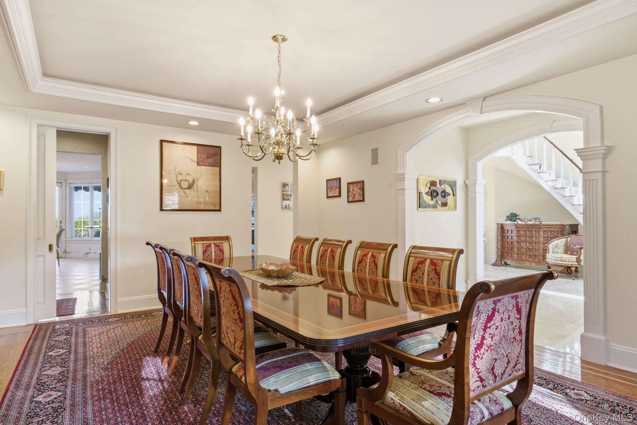 19 Cobblestone Court Centerport, NY 11721 - Photo 18 of 45 a view of a dining room with furniture and chandelier