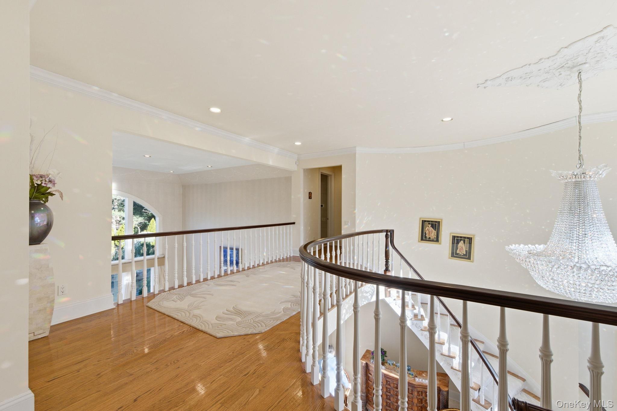19 Cobblestone Court Centerport, NY 11721 - Photo 24 of 45 a view of staircase with lots of frames on wall and a window