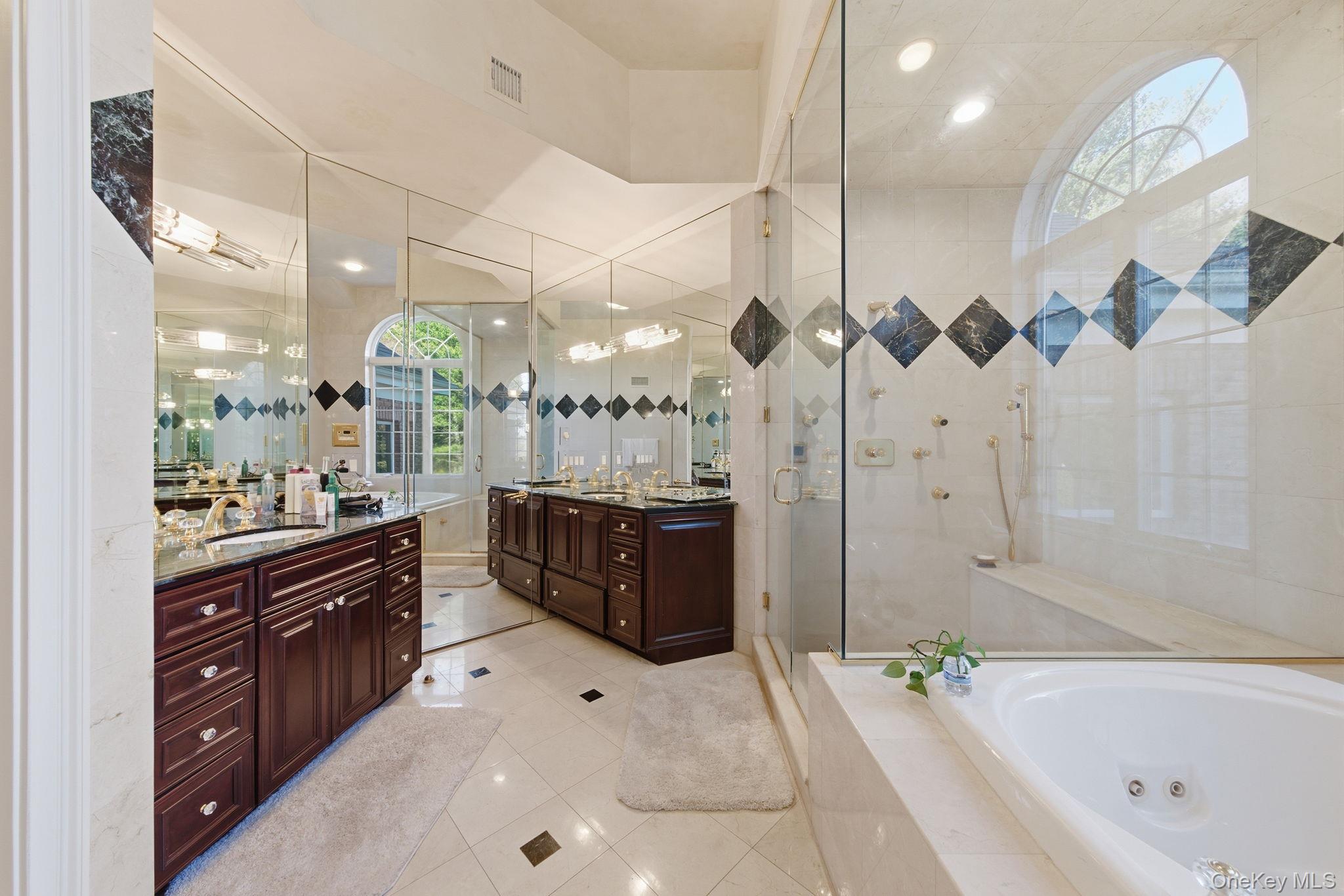19 Cobblestone Court Centerport, NY 11721 - Photo 30 of 45 a large bathroom with a tub a double vanity sink a mirror and a shower