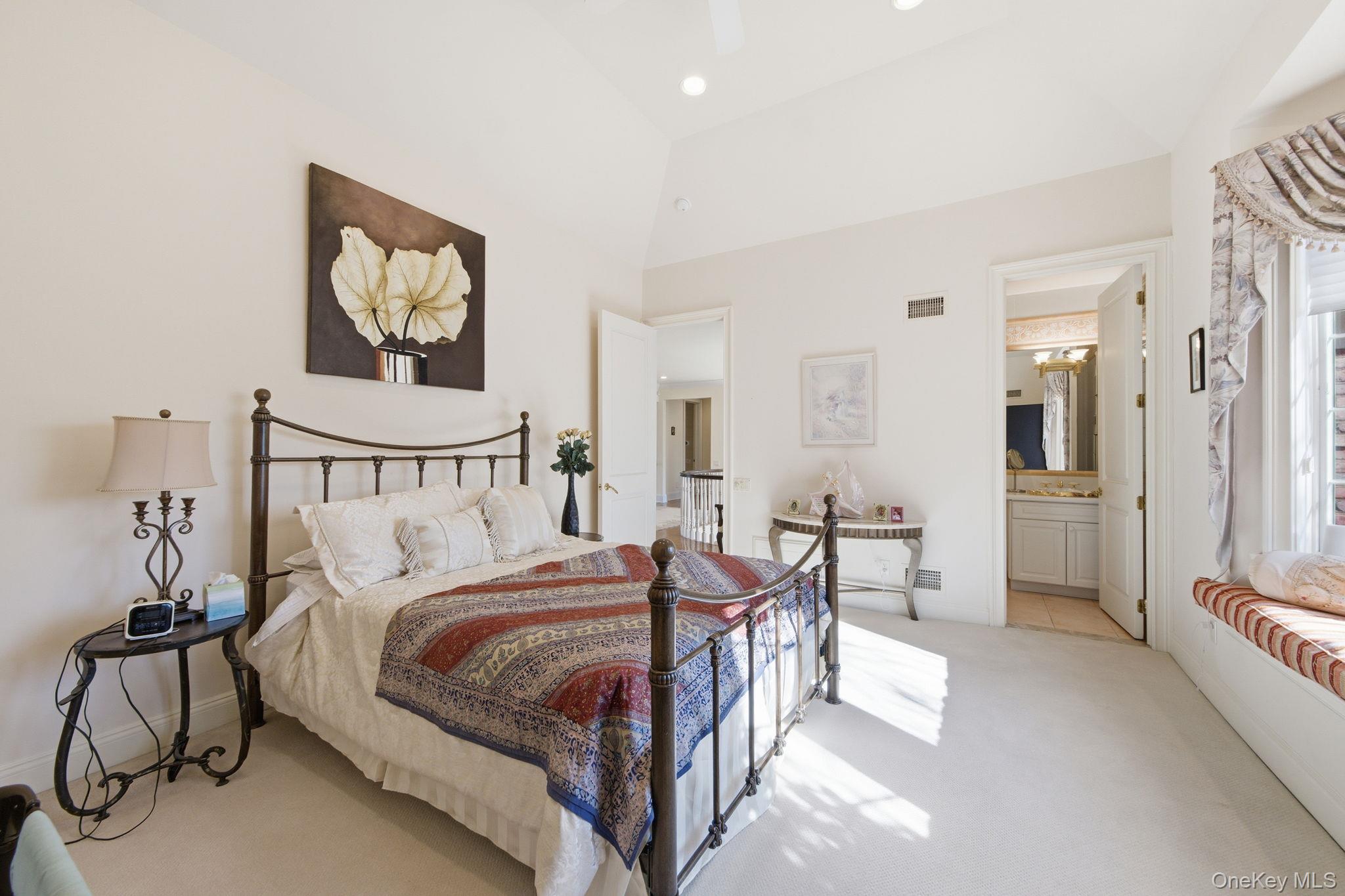 19 Cobblestone Court Centerport, NY 11721 - Photo 34 of 45 a bedroom with a bed and a chandelier