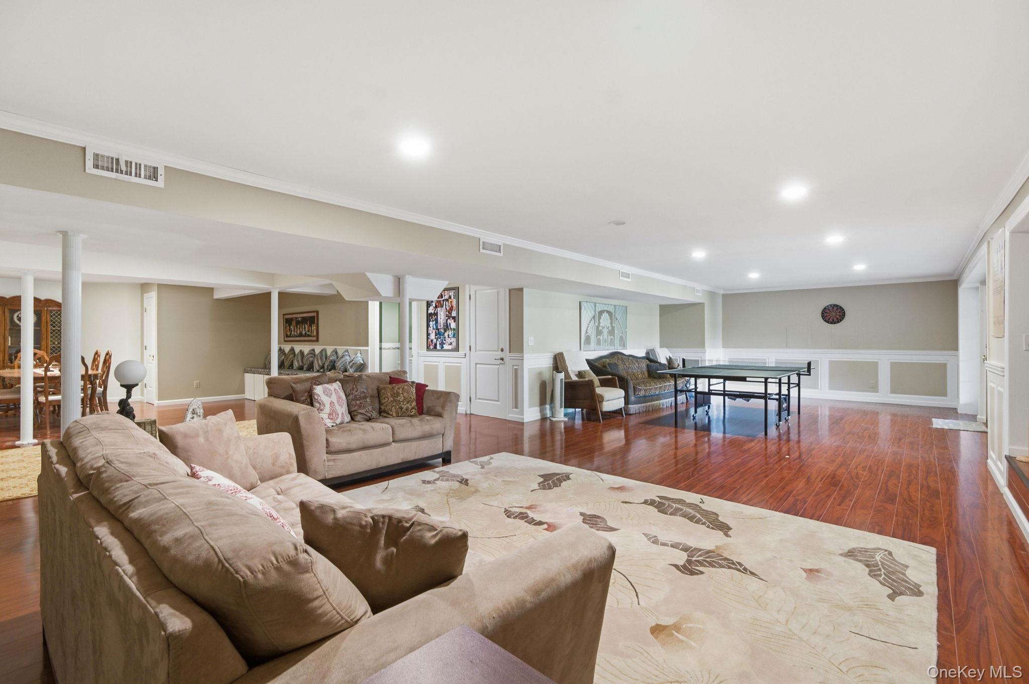 19 Cobblestone Court Centerport, NY 11721 - Photo 35 of 45 a living room with furniture and wooden floor