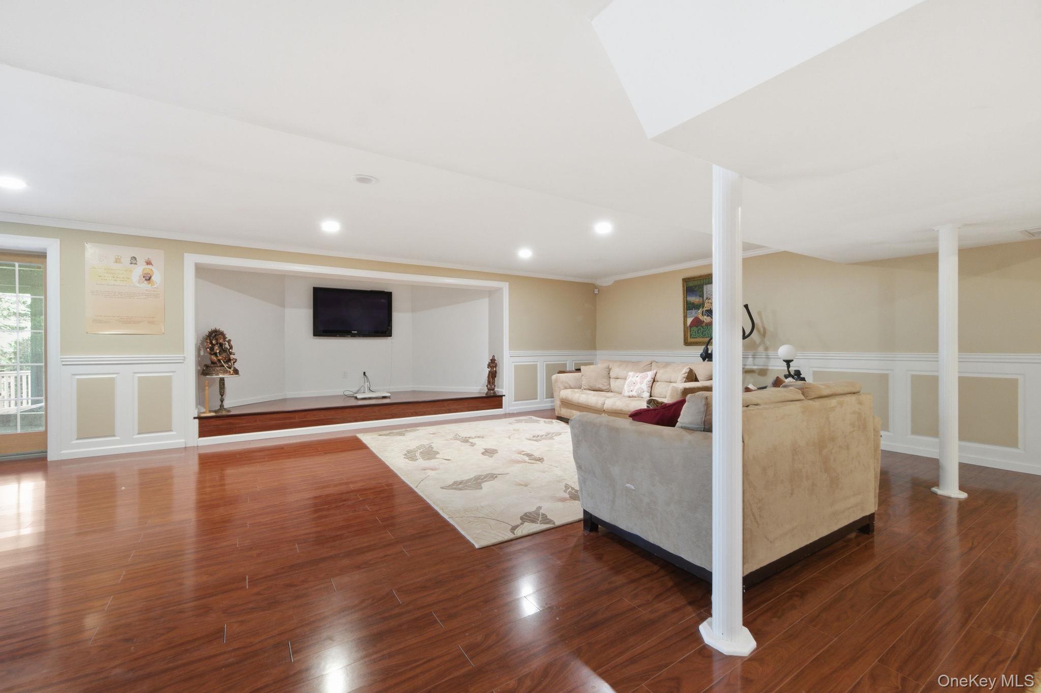 19 Cobblestone Court Centerport, NY 11721 - Photo 36 of 45 a living room with furniture and wooden floor