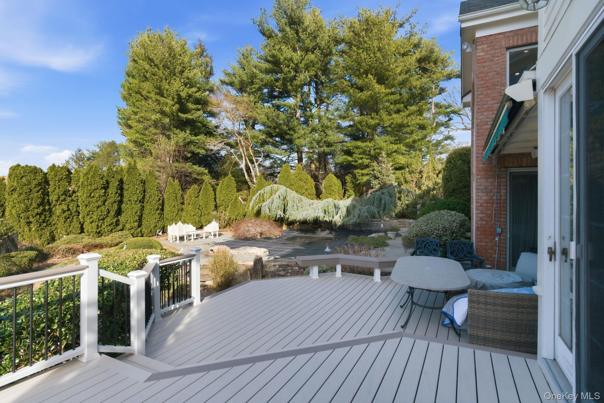 19 Cobblestone Court Centerport, NY 11721 - Photo 37 of 45 a terrace with outdoor seating and trees
