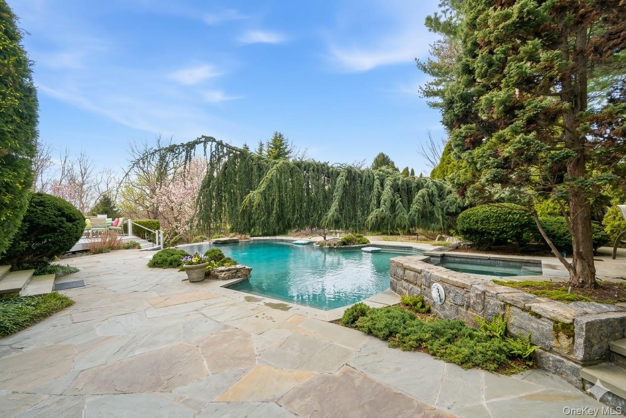 19 Cobblestone Court Centerport, NY 11721 - Photo 5 of 45 a view of swimming pool with outdoor seating and plants