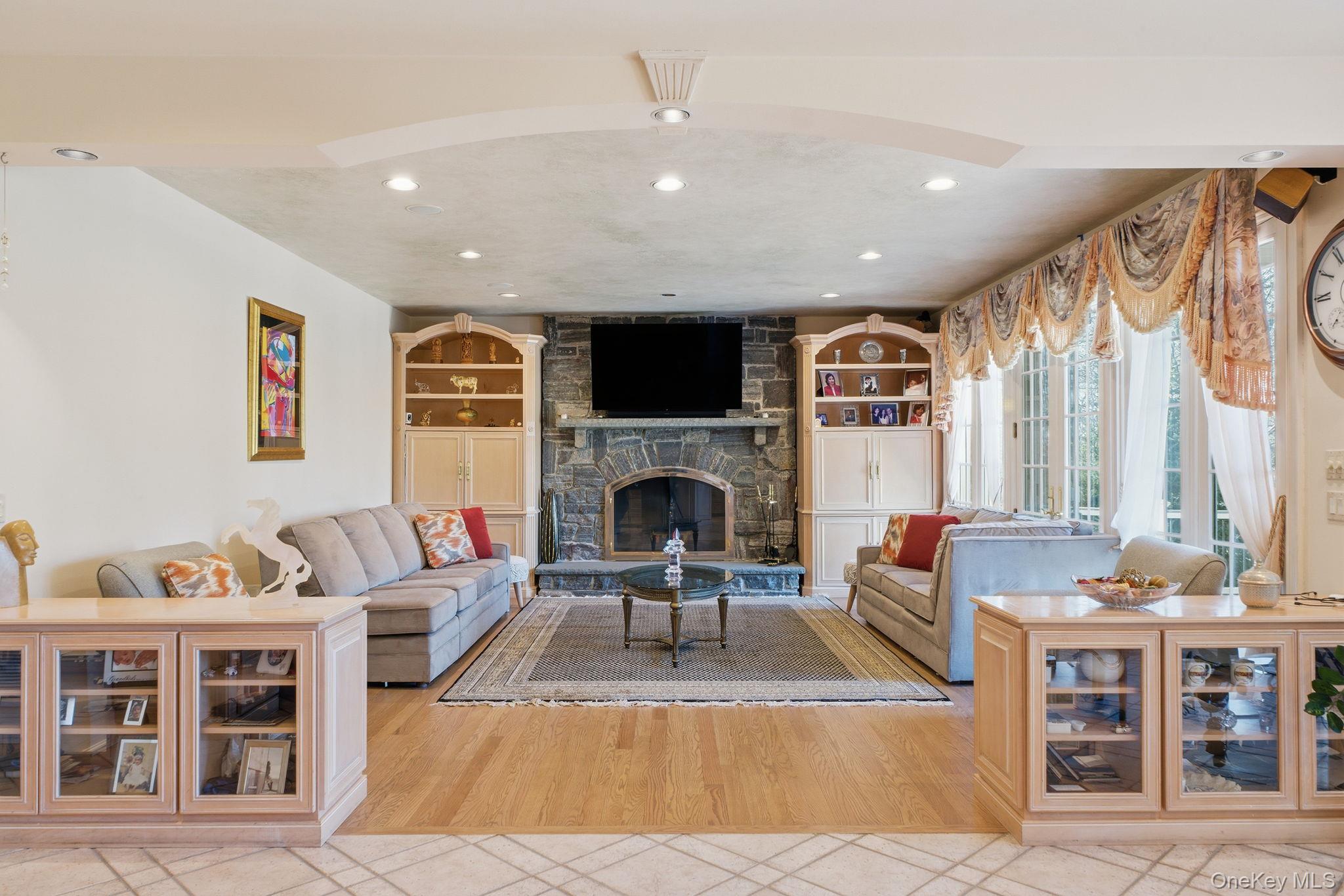 19 Cobblestone Court Centerport, NY 11721 - Photo 10 of 45 a living room with furniture fireplace and window