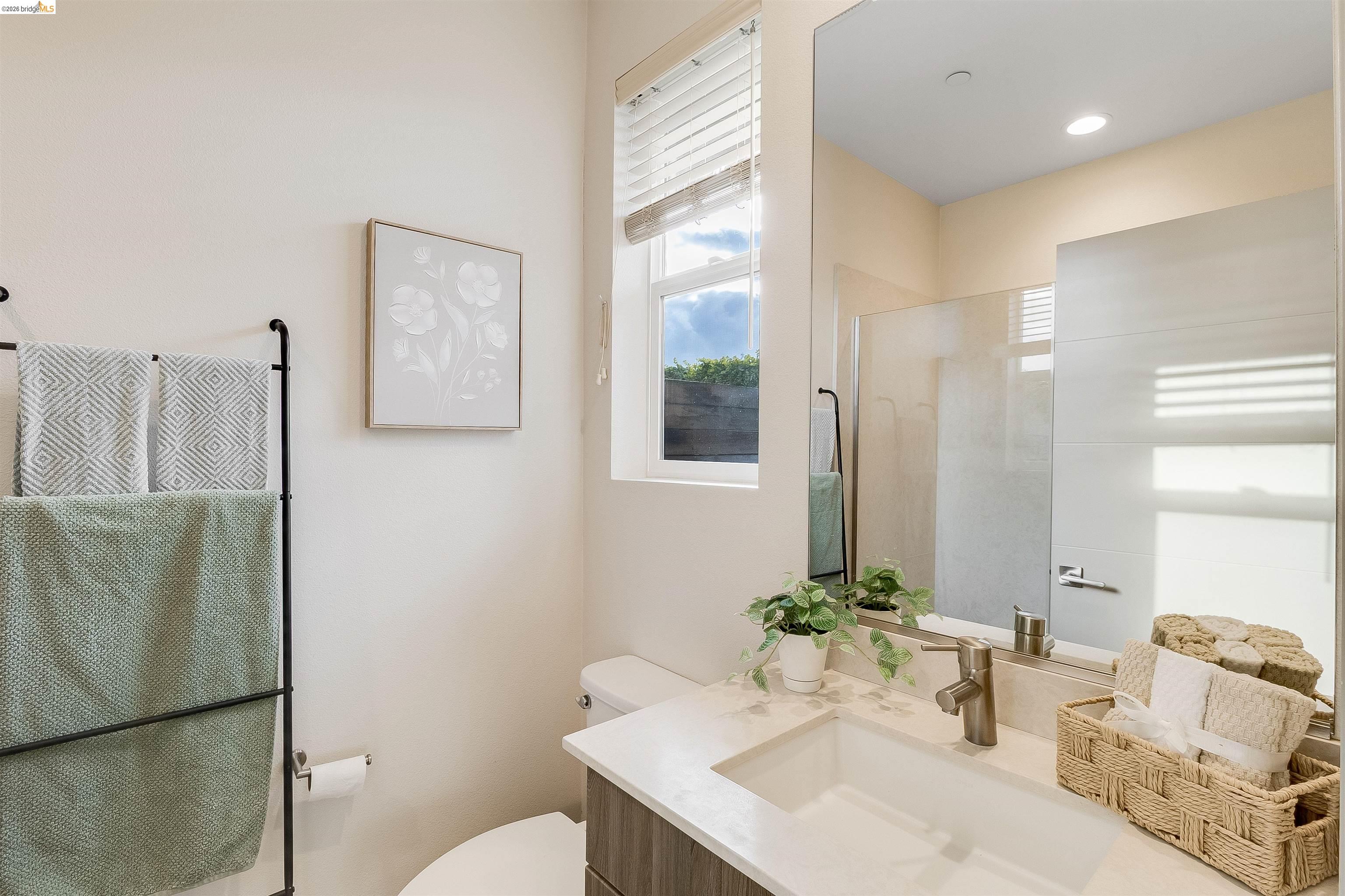 1357 Pullman Way Oakland, CA 94607 - Photo 7 of 37 Bathroom vanity featuring a rectangular undermount sink and a single-handle faucet, complemented by a large frameless mirror