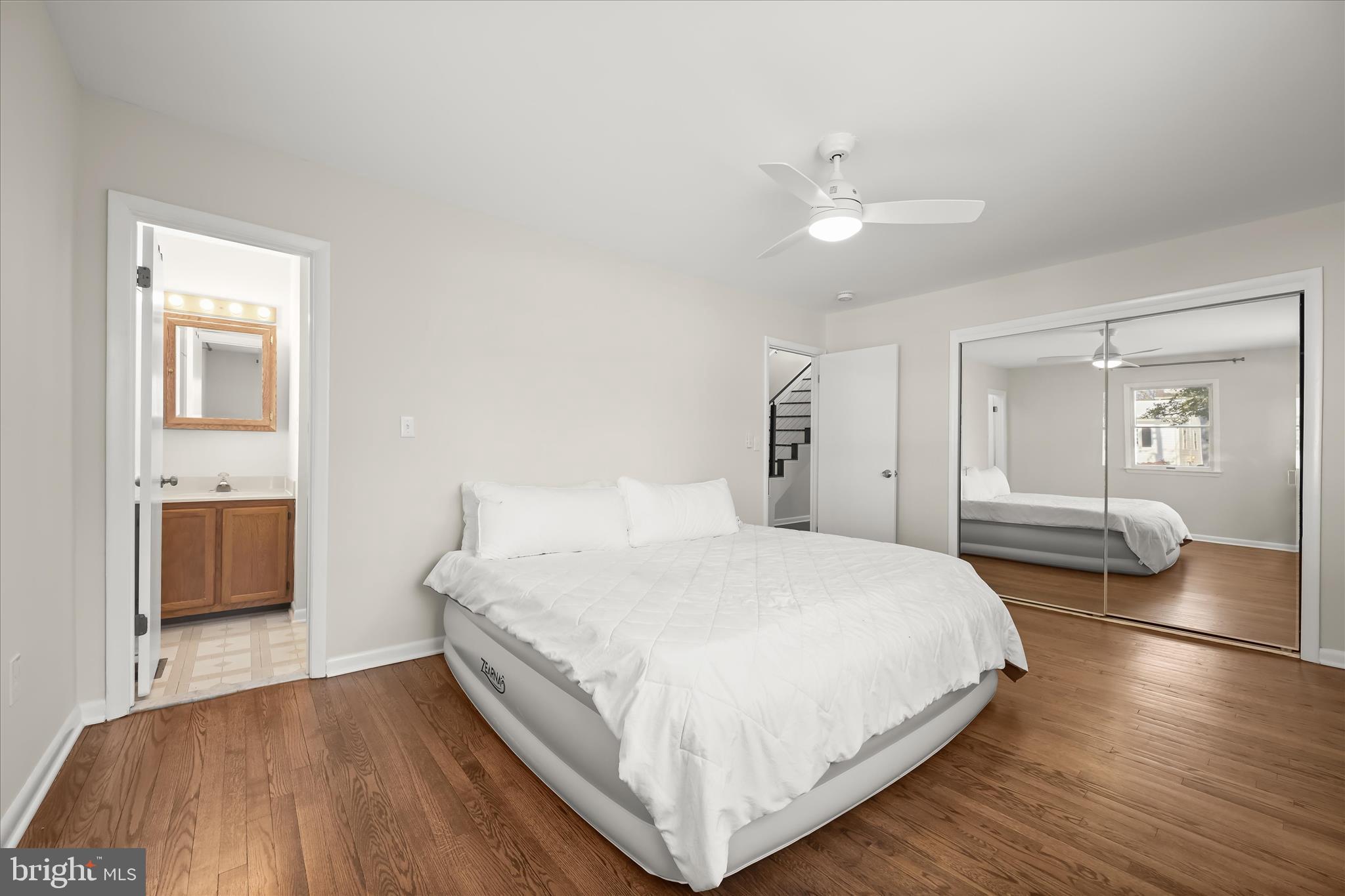 1443 Rehling Drive Edgewater, MD 21037 - Photo 16 of 54 a bedroom with a large bed and a chandelier