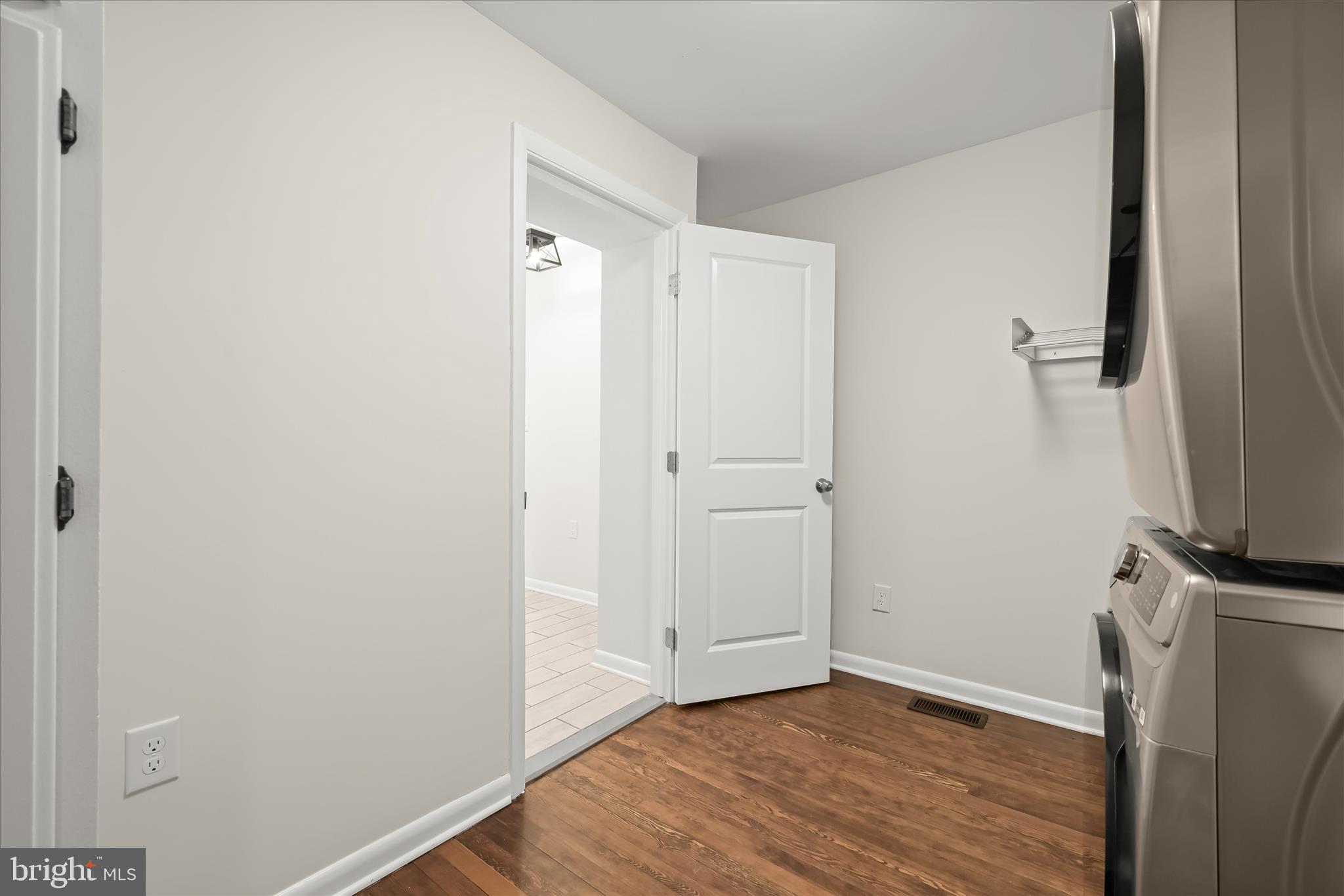 1443 Rehling Drive Edgewater, MD 21037 - Photo 22 of 54 a view of an empty room with wooden floor and a bathroom