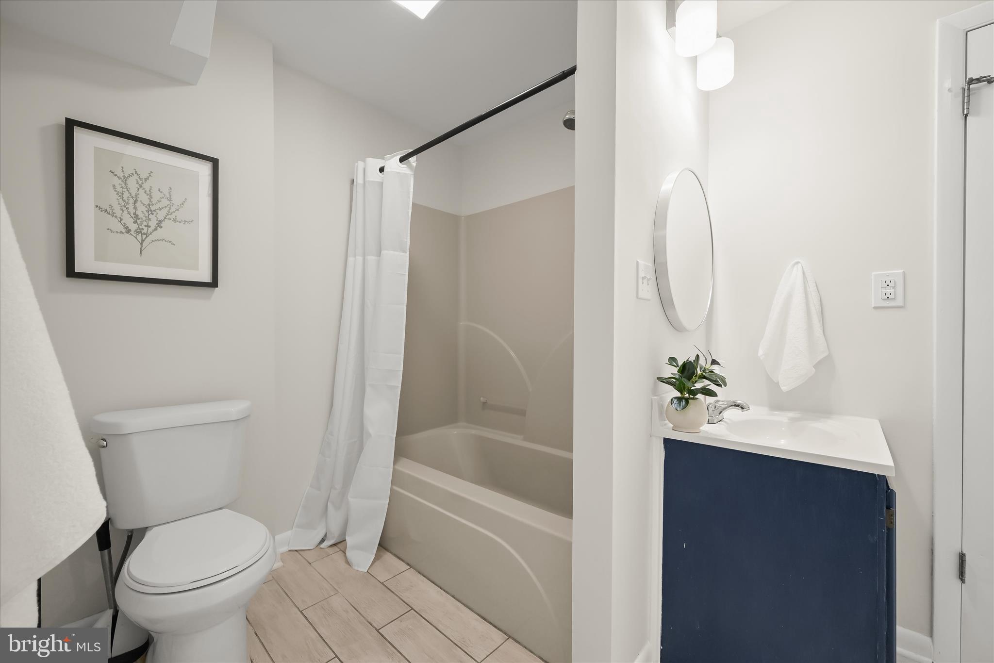 1443 Rehling Drive Edgewater, MD 21037 - Photo 23 of 54 a bathroom with a bathtub shower sink vanity and toilet