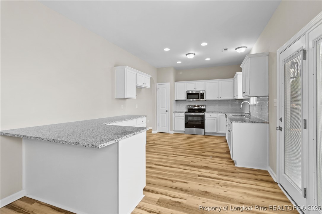 288 New Castle Lane Spring Lake, NC 28390 - Photo 15 of 39 a kitchen with granite countertop a sink and stainless steel appliances