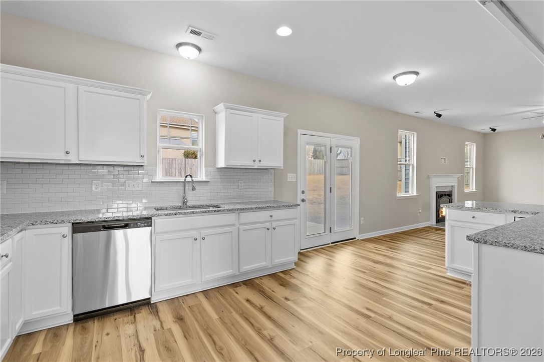 288 New Castle Lane Spring Lake, NC 28390 - Photo 18 of 39 a kitchen with granite countertop cabinets stainless steel appliances a sink and a window