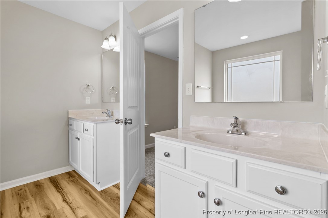 288 New Castle Lane Spring Lake, NC 28390 - Photo 24 of 39 a en suite bathroom with a sink and a mirror