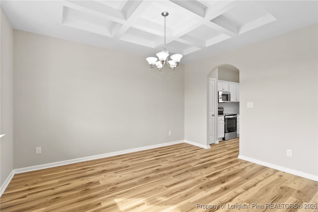 288 New Castle Lane Spring Lake, NC 28390 - Photo 7 of 39 a view of a chandelier fan and wooden floor