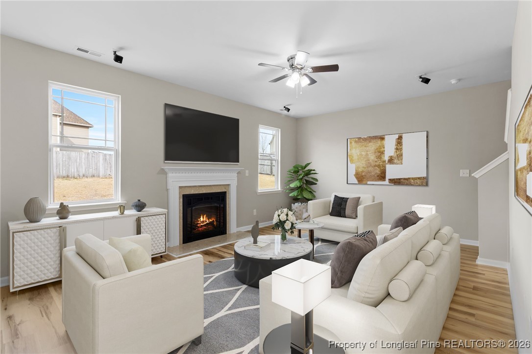 288 New Castle Lane Spring Lake, NC 28390 - Photo 10 of 39 a living room with furniture a fireplace and a flat screen tv
