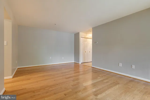 a view of an empty room and wooden floor