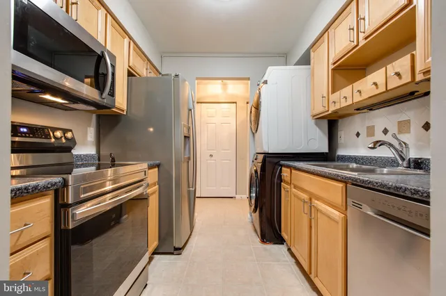 a kitchen with stainless steel appliances granite countertop a stove and a microwave