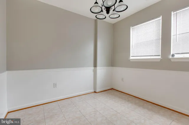 a view of room with window and chandelier fan