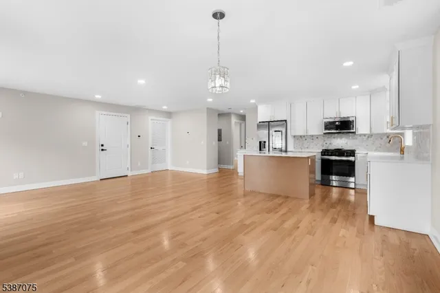 a view of a kitchen with microwave and cabinets
