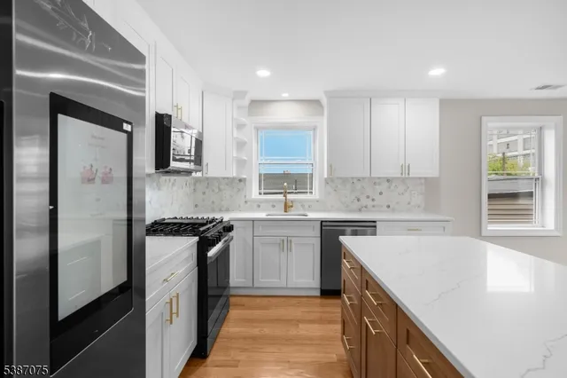 a kitchen with a sink stove top oven and refrigerator