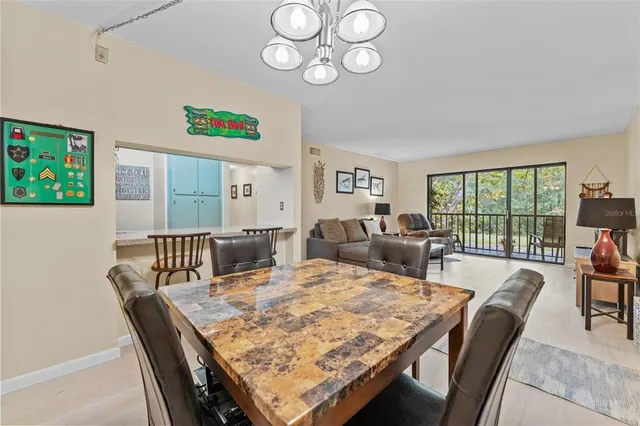 a view of a dining room with furniture a rug and wooden floor