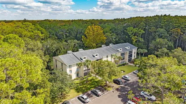 aerial view of a house with a yard and lake view