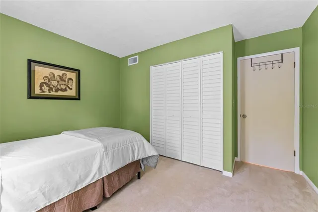 a bedroom with a bed and a wall painting