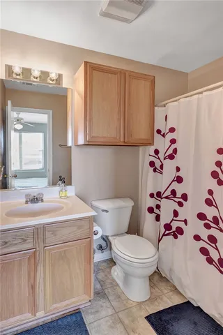 a bathroom with a sink a toilet and a mirror