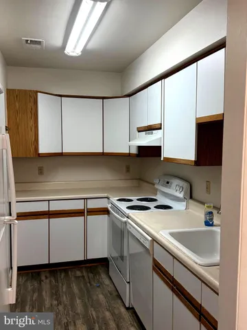 a kitchen with a sink cabinets and a window