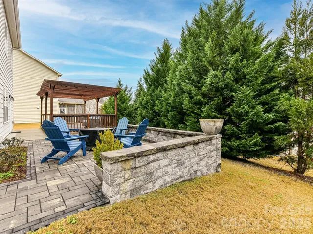 a view of a patio with table and chairs and potted plants