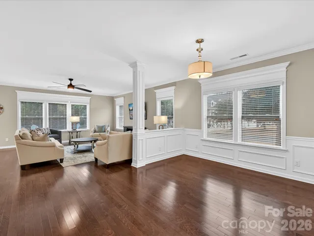 a living room with furniture and a chandelier