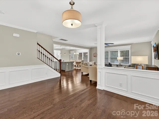 a open hall with wooden floor and windows